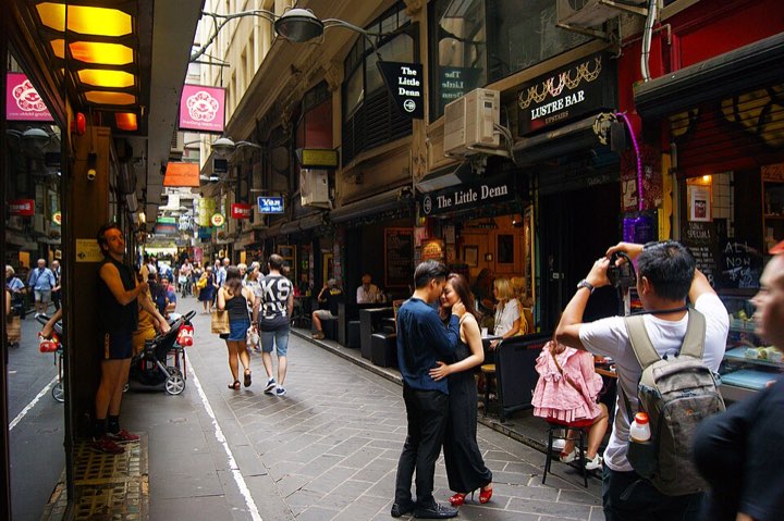 A busy Melbourne laneway lined with cafés and bars
